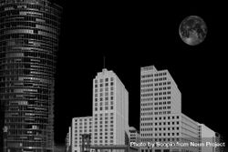 Negative photo of high-rise buildings under moon in Berlin, Germany 0yMBR0