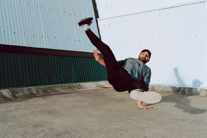 Man performing handstand near wall
