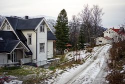 Amazing wintry view of countryside with colorful cottages against snowy hills