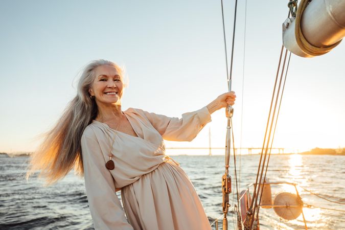 Radiant older woman on a yacht at dusk