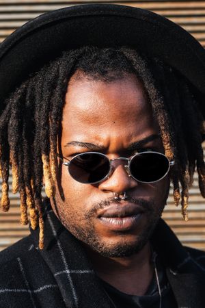 Stylish Black man with dreadlocks on street