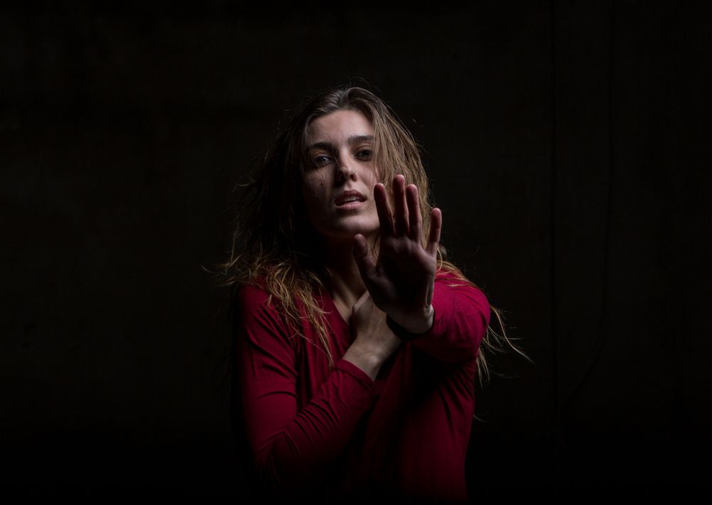 Young woman dancing in darkness