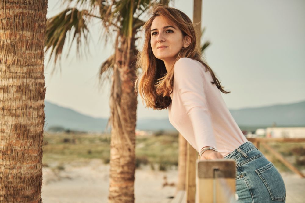 Woman on beach enjoying sunset