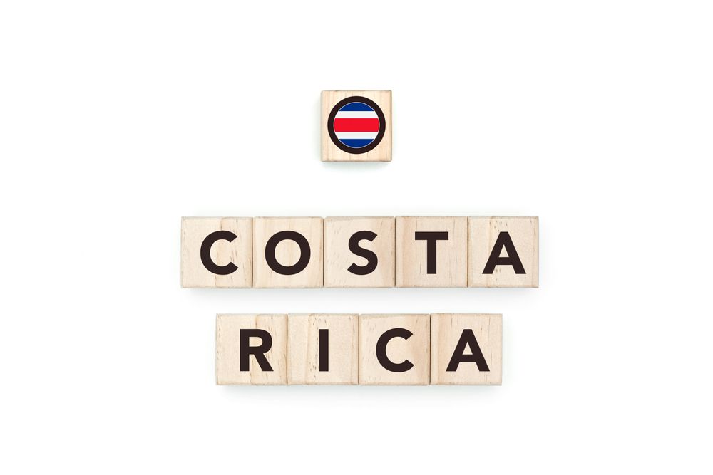 Wooden blocks bearing the name and flag of Costa Rica. Costa Rican and American Culture, national identity, travel, and geography in a copy space design.