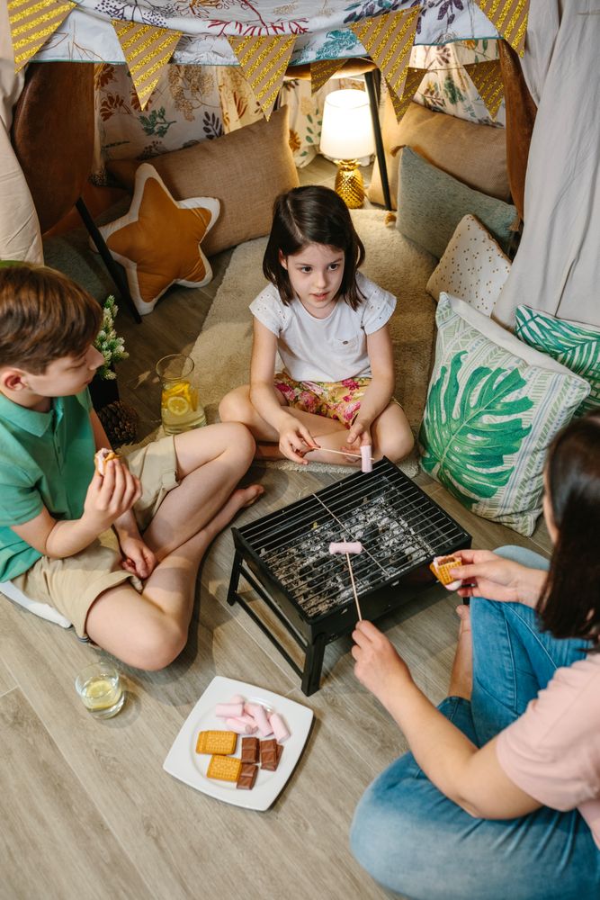 Family preparing s'mores with barbecue at home