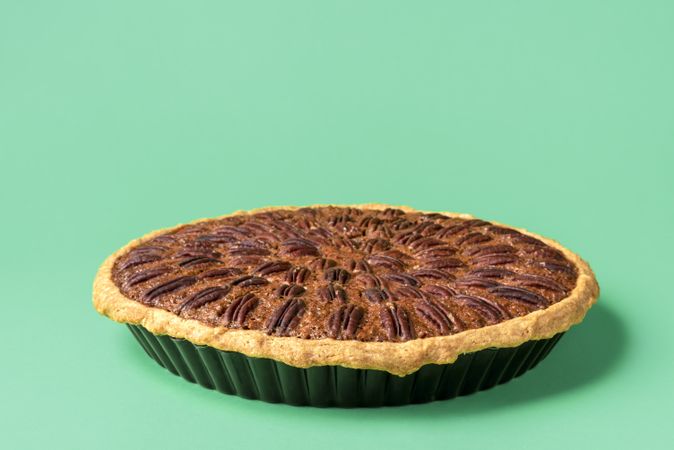 Pecan pie close-up isolated on a green background