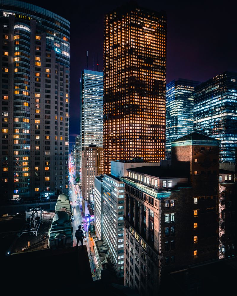 Cars on road between high rise buildings