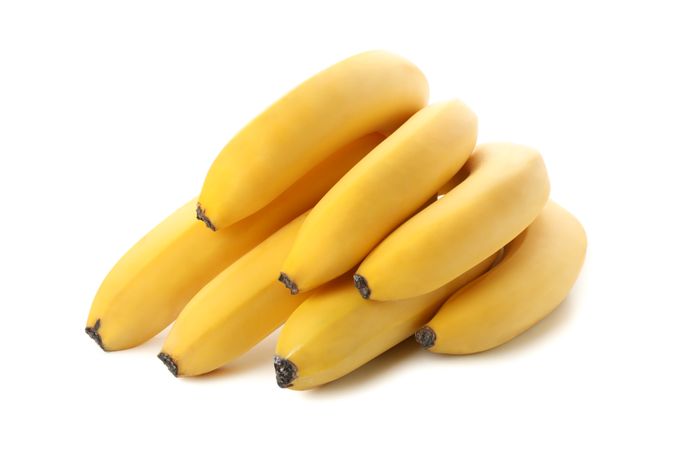Banana cluster isolated on light background. Fresh fruit