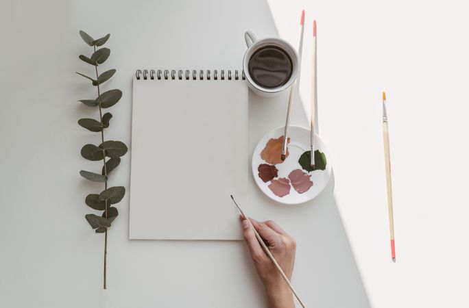 Person drawing flowers with watercolor