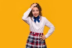 Girl with hand on head, confused expression