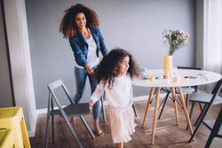 Mother and daughter play in the dinning room