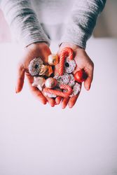 Woman holding festive cookies and candy cane treats