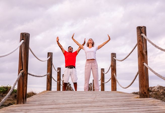 Couple practicing martial arts on lumber path