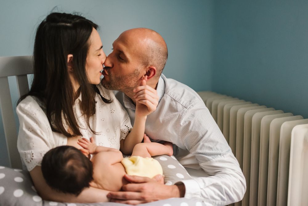 Happy parents feeding baby
