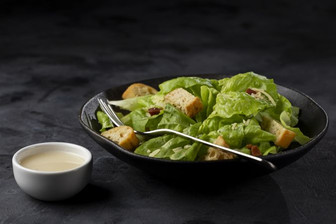 Caesar salad with croutons and bacon.