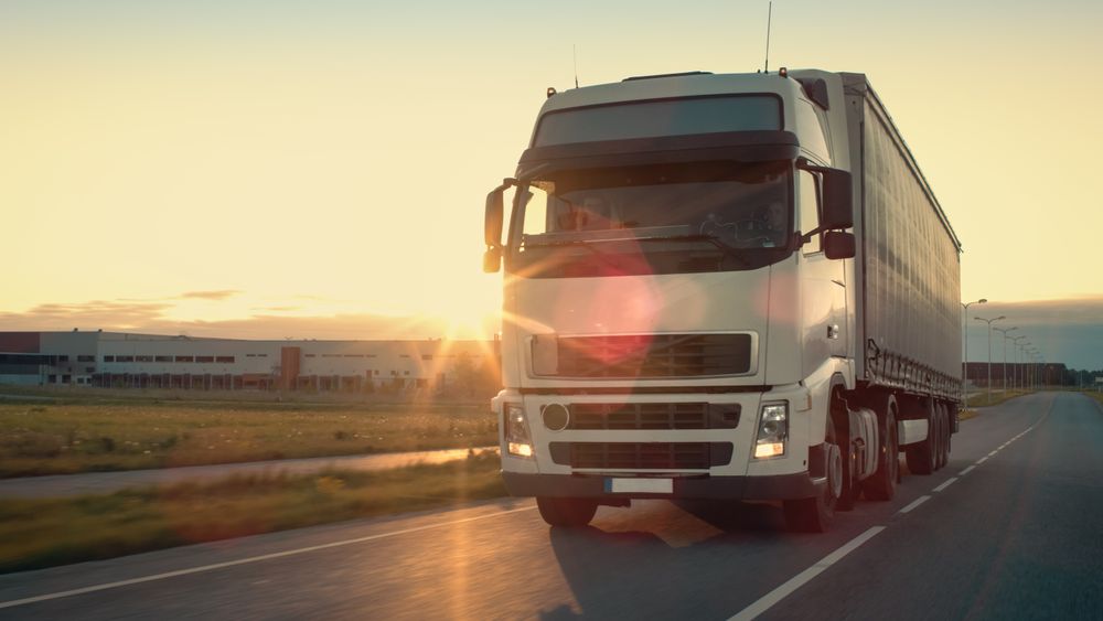 Front-View of Semi-Truck with Cargo Trailer Driving on a Highway.