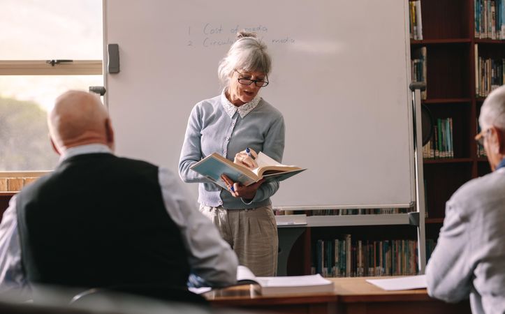 Older female professor teaching in classroom