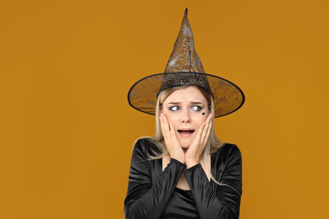 A woman in a Halloween costume is very terrified