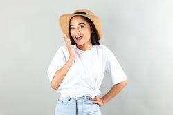 Happy Asian Woman in Summer Casual Clothes and Beach Hat