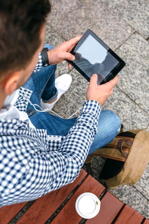 Unrecognizable young man using tablet