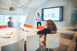 Group of people enjoying a presentation in an open modern office