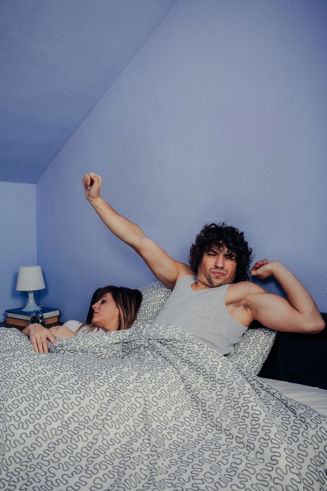 Man waking up while his wife sleeps