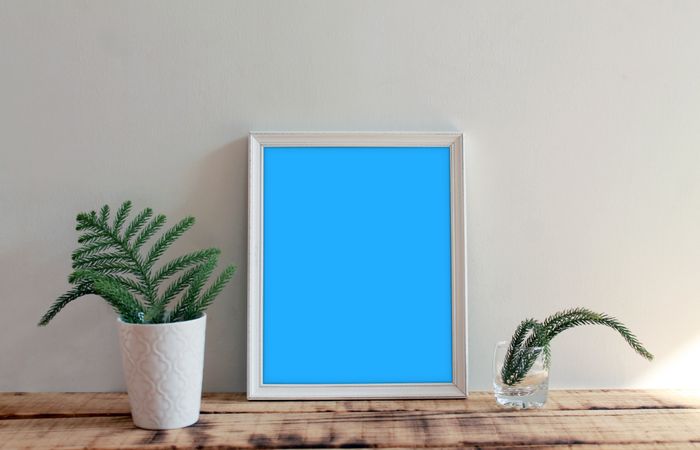 Rectangular long picture frame with blue interior mockup with branches in vase