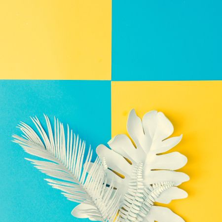 Painted tropical and palm leaves on cyan and yellow background
