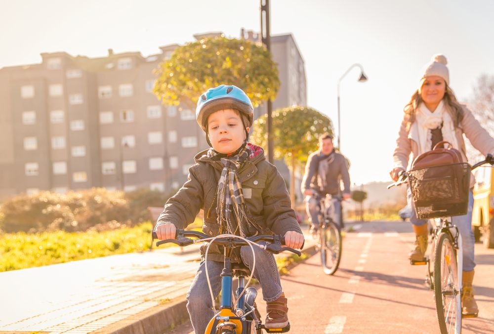 Little boy leading mom and dad on family bike ride