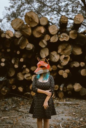 Enigmatic woman in red fox mask