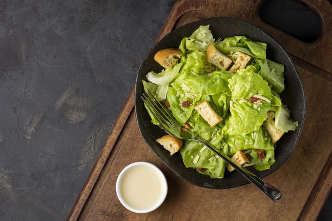 Caesar salad with croutons and bacon.