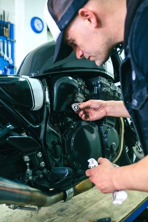 Mechanic repairing customized motorcycle