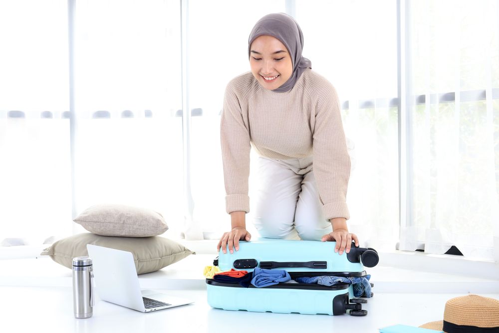 Woman Preparing Suitcase for Summer Vacation Travel Trip