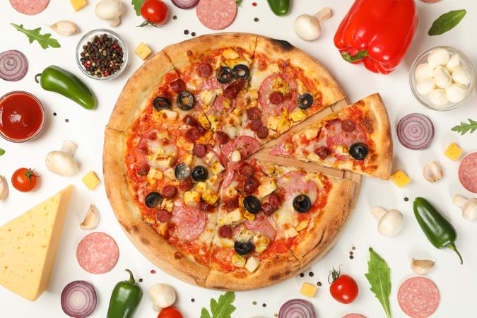 Pizza with meat and ingredients on plain background