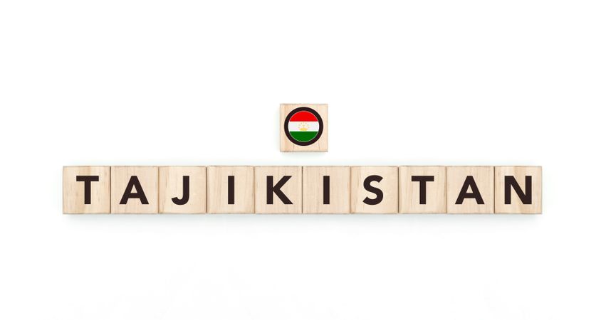 Wooden blocks bearing the name and flag of Tajikistan. Tajikistani and Asian Culture, national identity, travel, and geography in a copy space design.
