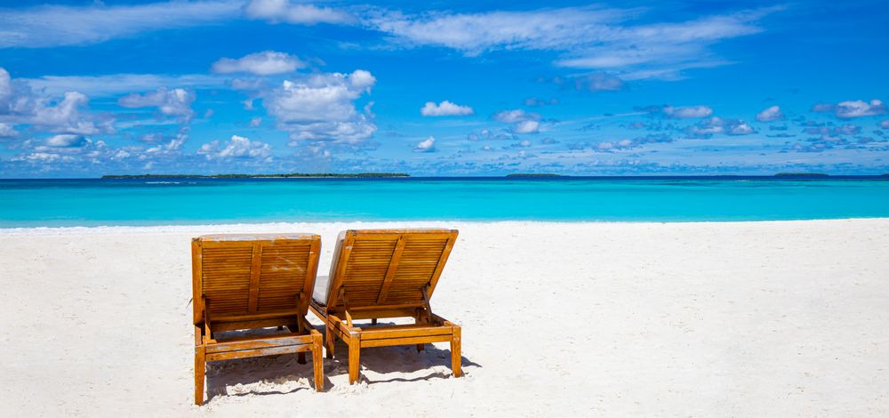 Blue sky over a tropical beach with blue water and sand