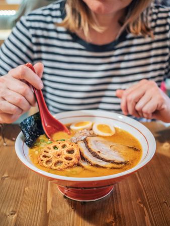 Female eating Japanese dish