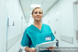Portrait of mature female nurse working in hospital 4OYvv0