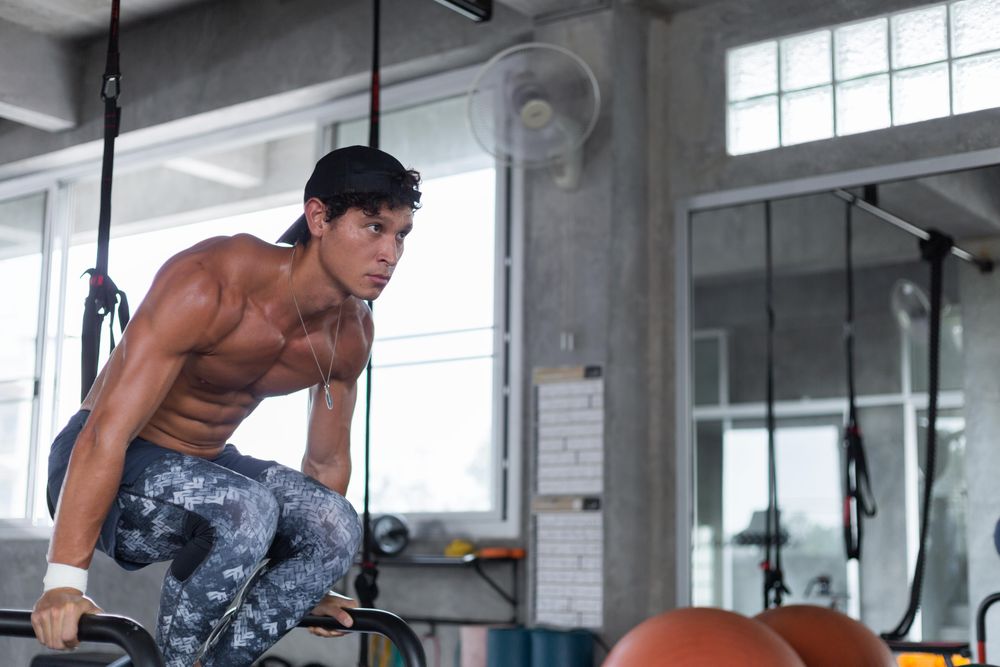 Male doing triceps dips at gym