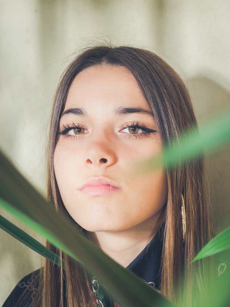 Woman between green leaves