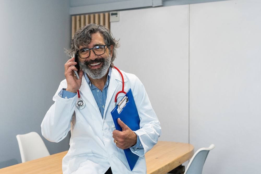Doctor using smartphone in medical office