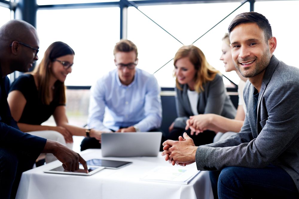 Businessman with his colleagues having an informal meeting in an office