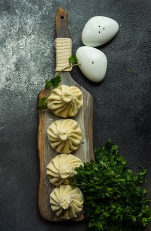 Top view of serving of Georgian khinkali dumplings with cilantro garnish
