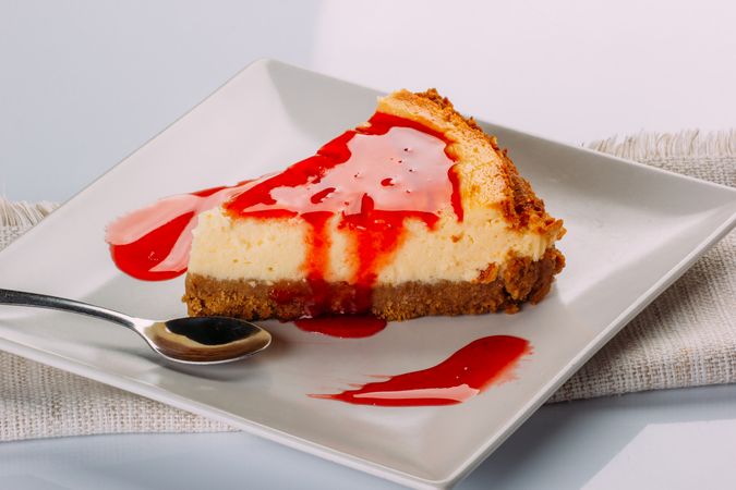 A piece of strawberry cheesecake on a plate