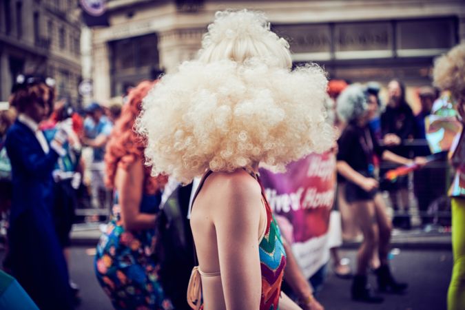 London, England, United Kingdom - July 7th, 2019: Woman in a huge blonde wig at Pride Parade