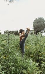 Man training yoga on meadow