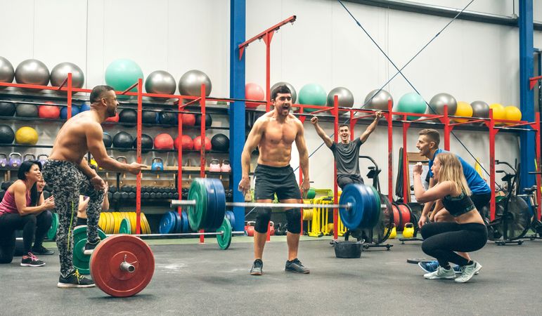 Man celebrating he is the winner of a weightlifting championship