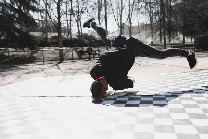 Man dancing break dance in park