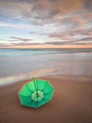 Umbrella on beach near sea