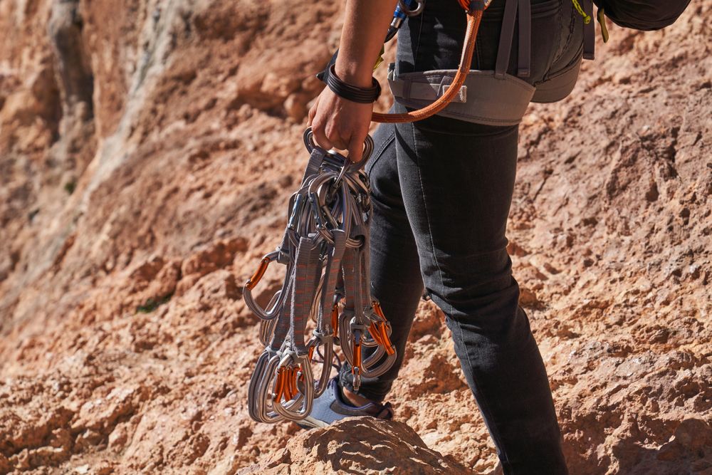 Unrecognizable mountaineer with climbing equipment